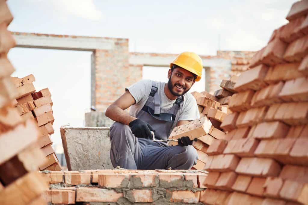 Man is on the construction site to complete project for brickwork in west sussex