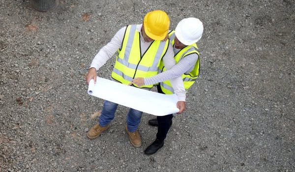 Construction site workers reviewing plans.